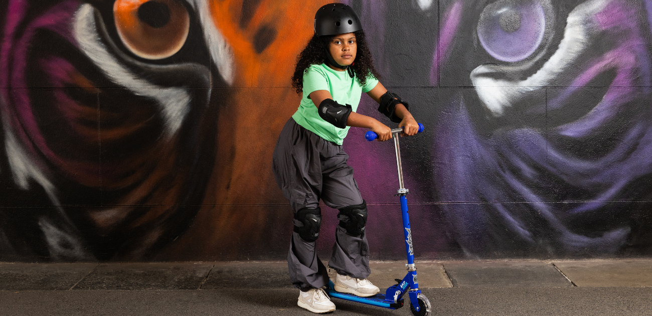 Child riding a Xootz scooter outdoors, perfect for summer adventures and active play.”