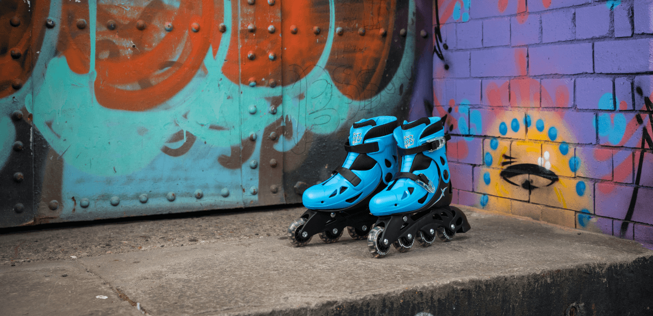 Pair of blue roller skates against colorful graffiti, highlighting the fun and fitness benefits of skating.