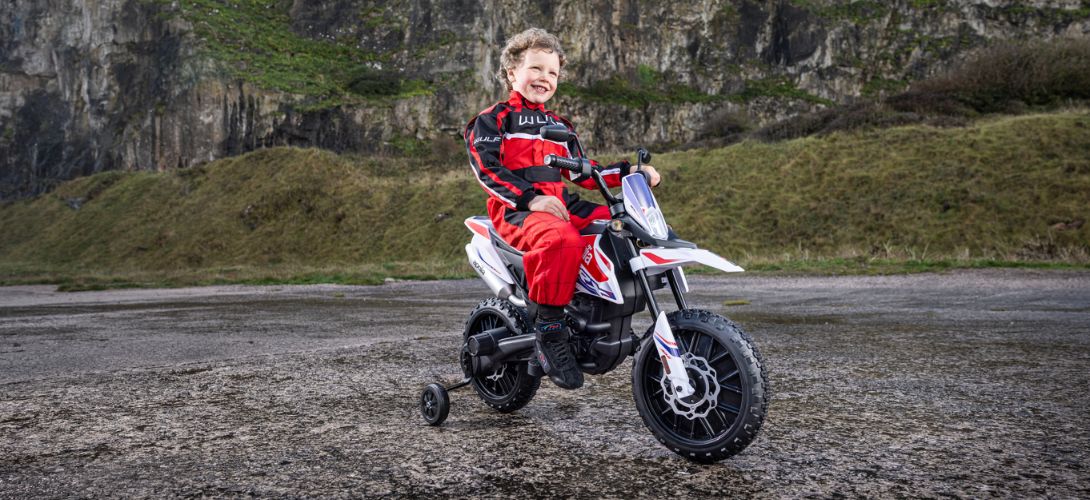 A photo of a young boy at a quarry riding a kids Aprilia bike