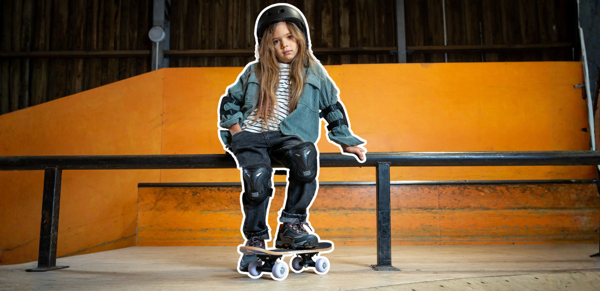 Child standing on a skateboard with feet positioned on the deck learning to skateboard for beginners