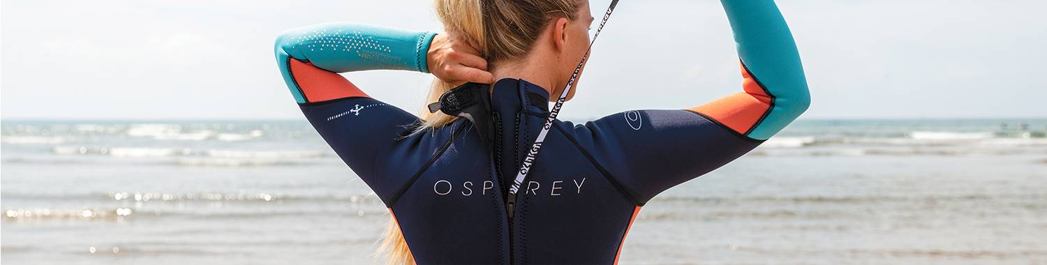 A wetsuit being zipped up from behind